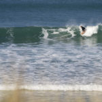 Sarah taking off on the otter surfboards wood burner Wooden surfboard at Gwithian, Cornwall