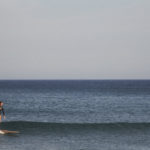 Sarah finding a ripple in the sun on the otter surfboards Pieces of Eight Wooden surfboard at Chapel Porth, Cornwall