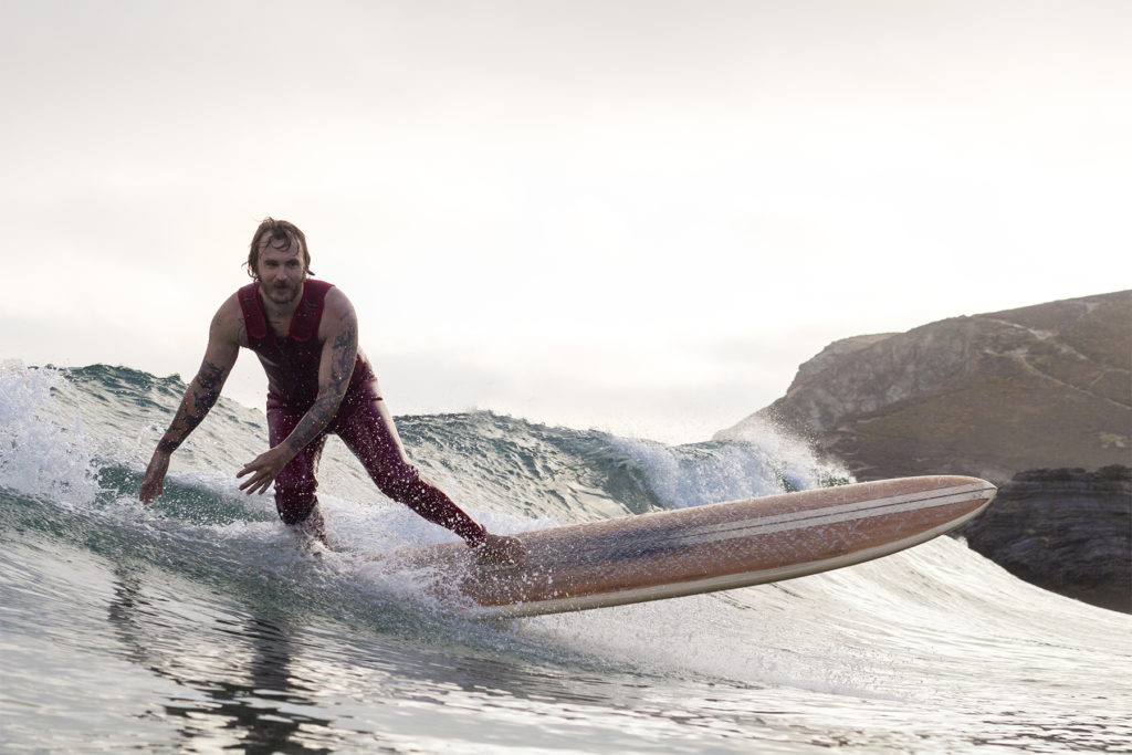 Rob stalls his wooden longboard at St Agnes Cornwall. Otter Surfboards Wicket.