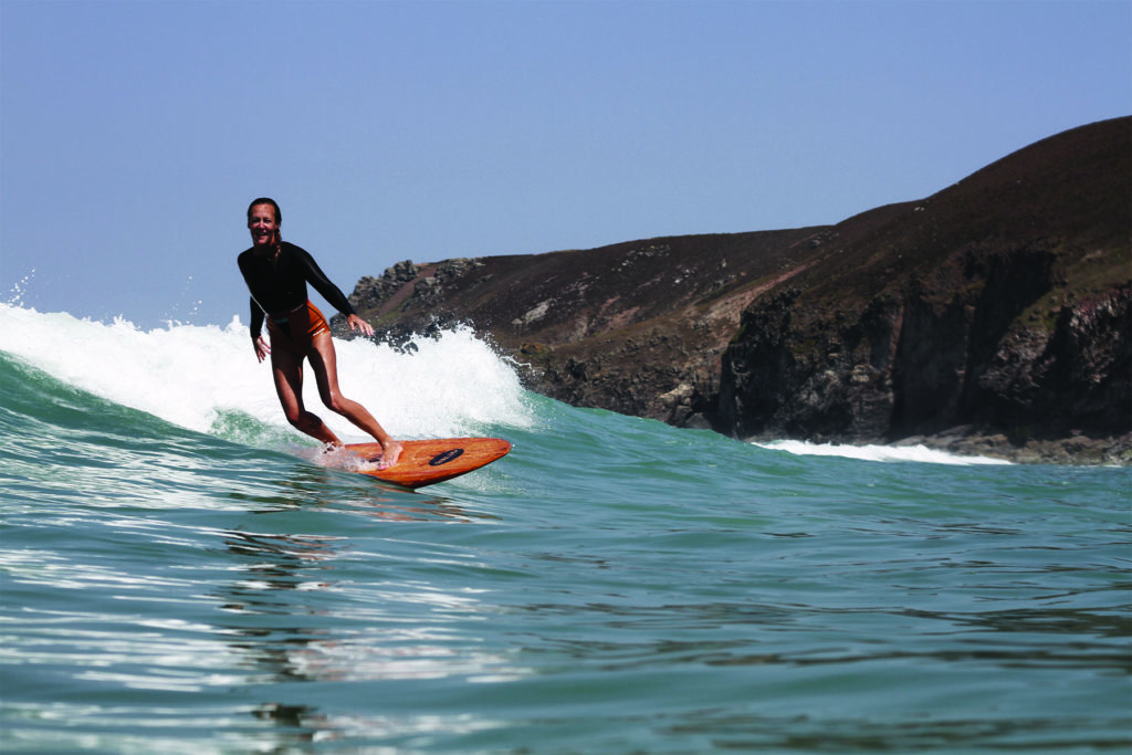 Sarah enjoys a wave on the Woodburner at Chapel Porth, Cornwall. Otter Wooden surfboard