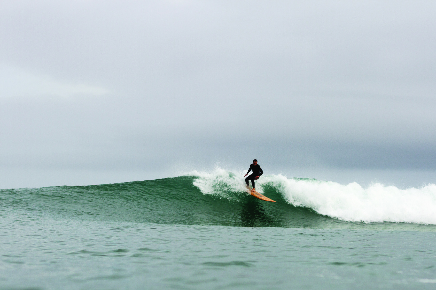 Chris top turns on the Pier. Otter wooden surfboards, Chapel Porth, Cornwall.