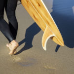 wooden surfboard and wooden fin james otter on the beach