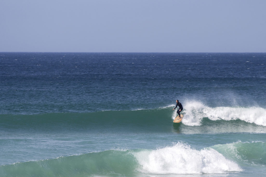 James Otter on his Wicket Wooden surfboard surfing in Cornwall