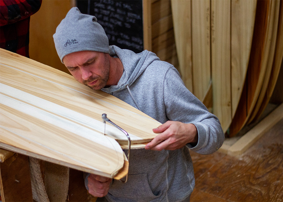 james Otter wooden surfboard workshop course cornwall with jonas cutting the fish tail