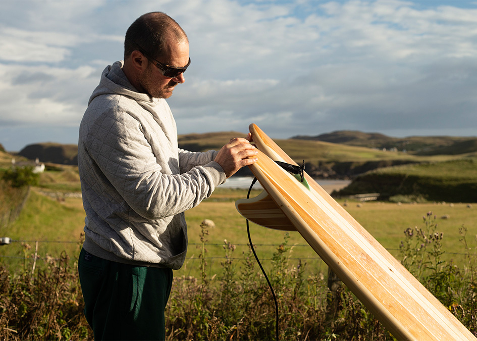 Lewis Arnold Sandy Kerr Easkey Britton Chris Noble Solstice Film Wooden Surfboards Scotland Hebrides Otter looking at surfboard rails