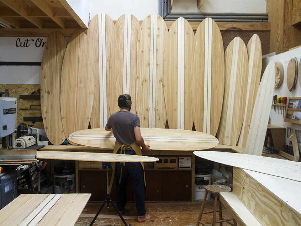 Chris prepping wooden surfboard skins in the otter workshop