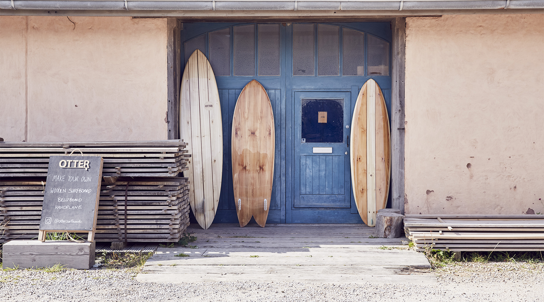 wood and surfboards outside the otter workshop
