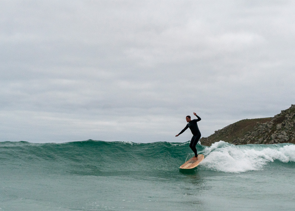 sam bleakley navigates a hollow runner on an otter surfboards wooden longboard