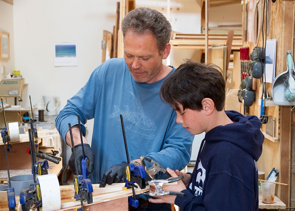 otter wooden surfboard workshop clamping