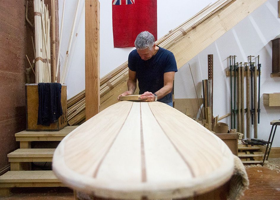 Otter wooden surfboard workshop sanding