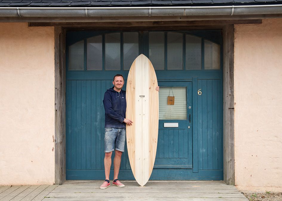 otter wooden surfboard workshop blue doors