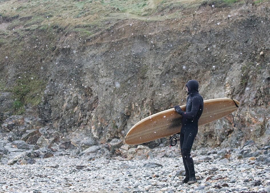 Otter wooden surfboard snow beach
