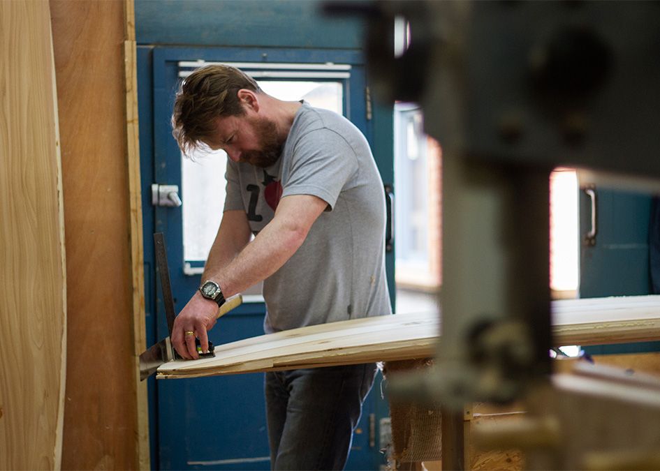 Otter wooden surfboard workshop sawing