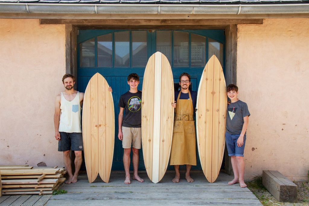 Otter wooden surfboard workshop blue doors