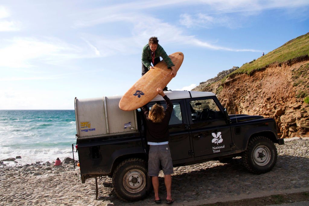 James Otter Nick Holden National Trust Wooden Surfboard Handover at Chapel Porth Landrover