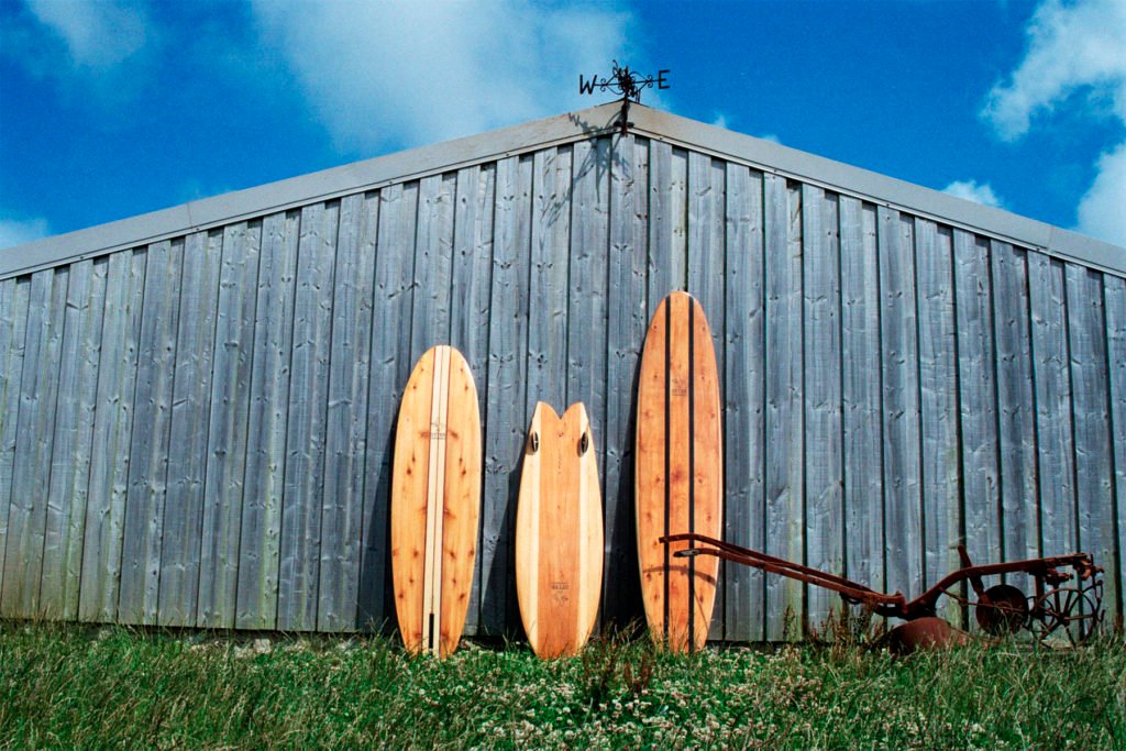 The Storyboard by James Otter and Mat Arney Wooden Surfboard Project surfboards against barn