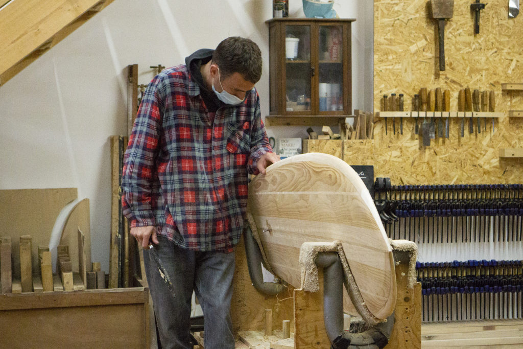 Harry, Chris and James Otter with wooden surfboards at the otter surfboards workshop in cornwall harry feeling rail