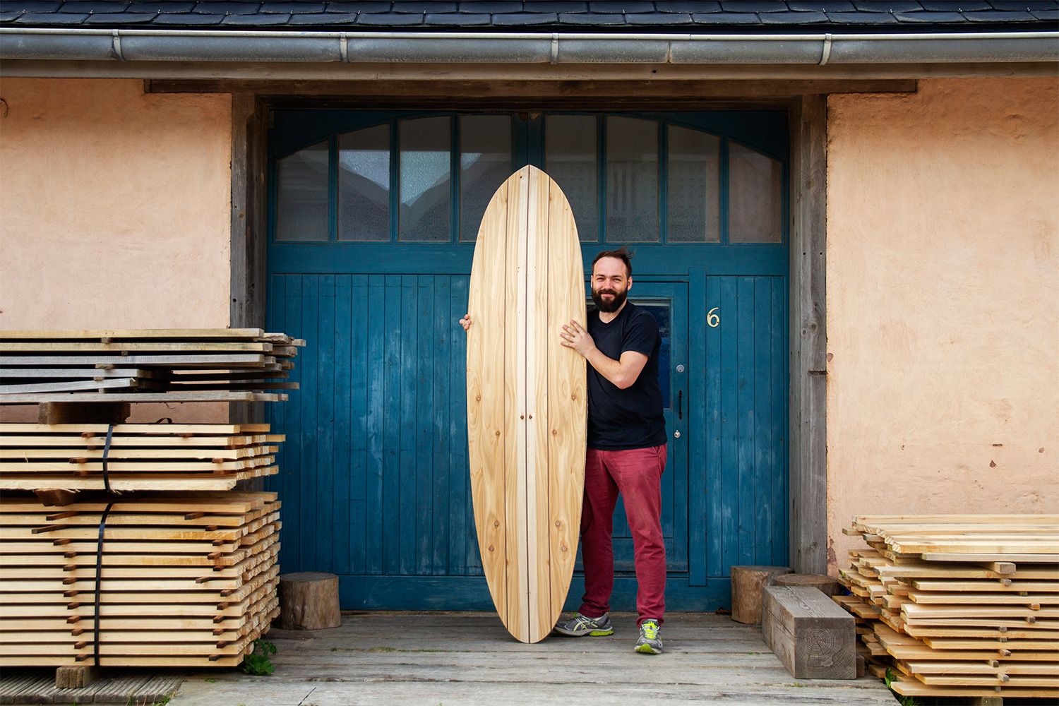 Wooden surfboard workshop otter blue doors