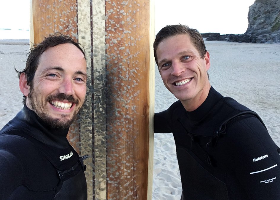 Otter Surfboards Wooden Surfboard Workshop Course Porthtowan Cornwall Guillaume and James on the beach with wooden longboard