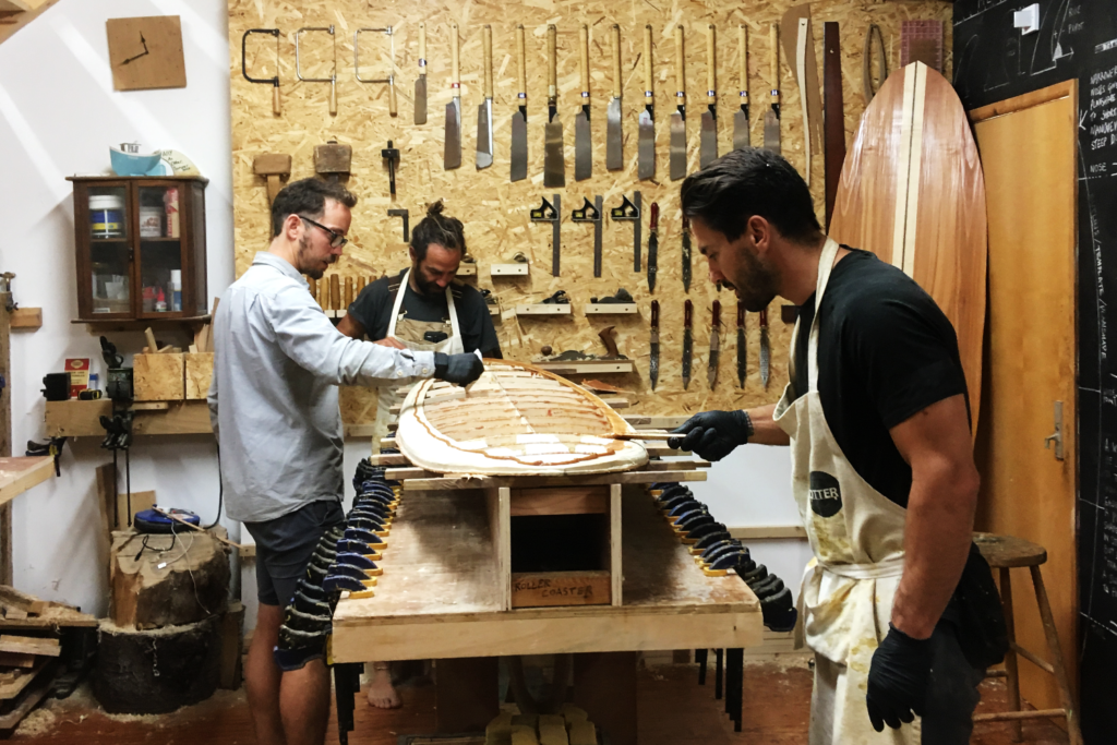 Otter Surfboards wooden surfboard making course with Ben and Marlow gluing decks down