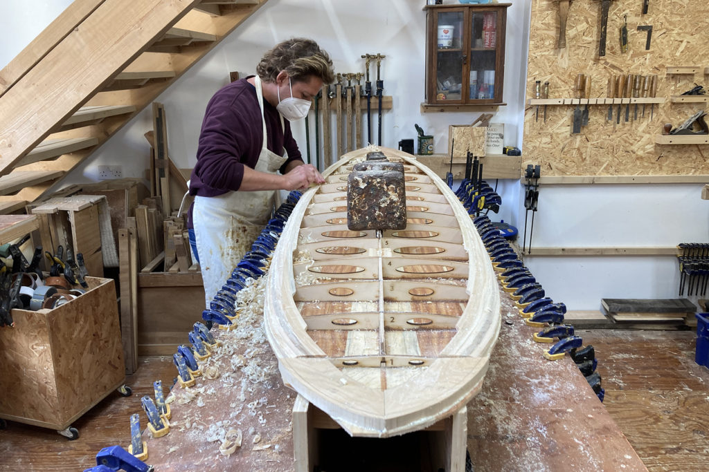 Sam prepping rails for deck wooden surfboard