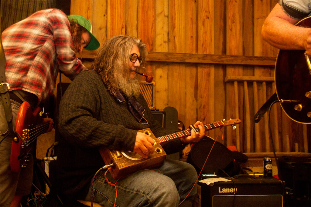 Rincon bear playing jeff sacree dirtbox guitar