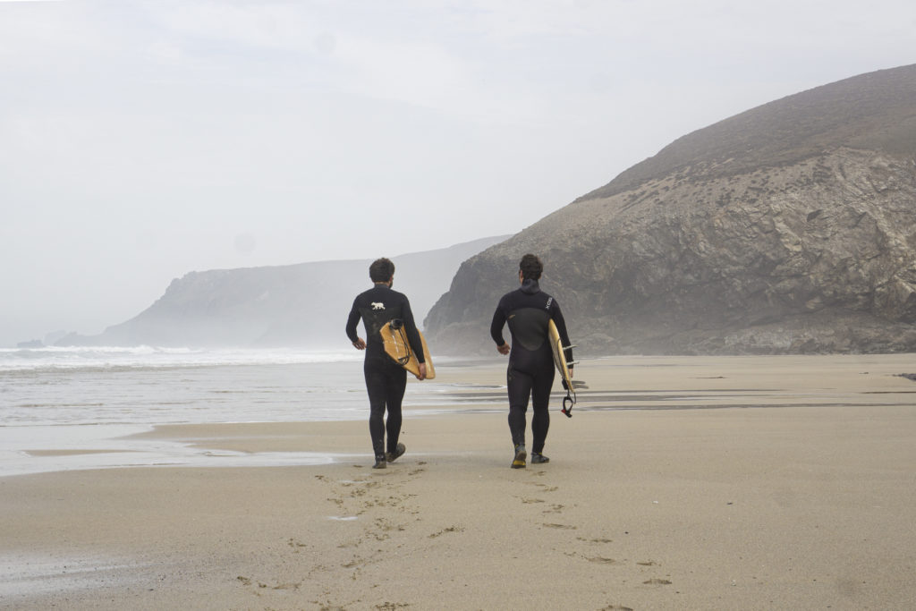 Monday Morning Surf Club Chris and James walking away along the beach