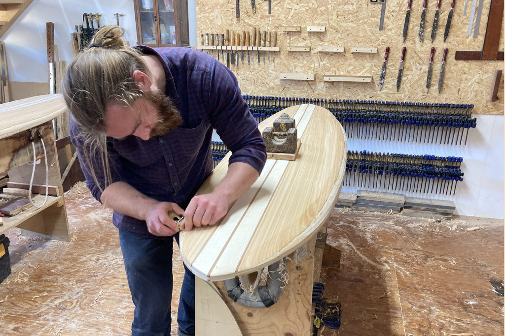 Otter wooden surfboard workshop course shaping tail