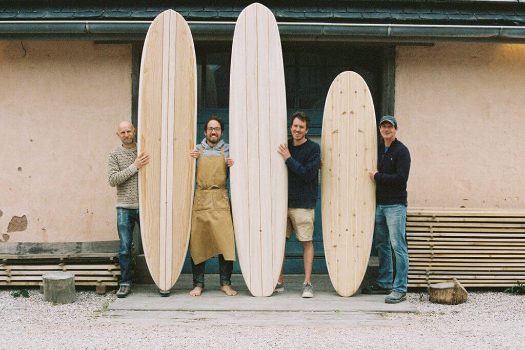 otter wooden surfboard workshop blue doors