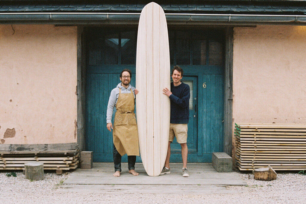 otter wooden surfboard workshop blue doors