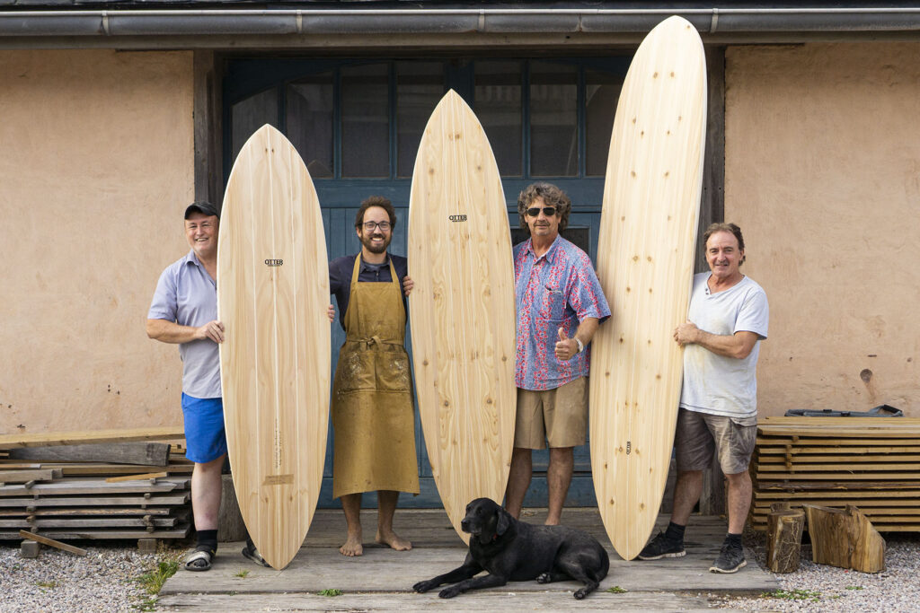 otter wooden surfboard workshop blue doors