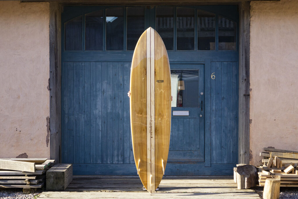 otter wooden surfboard finished blue doors
