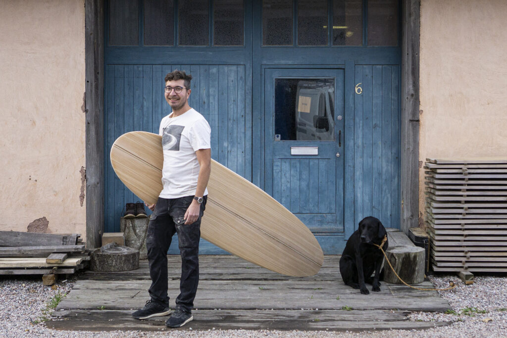 otter wooden surfboard workshop blue doors