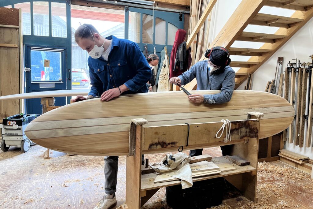 otter wooden surfboard workshop shaping