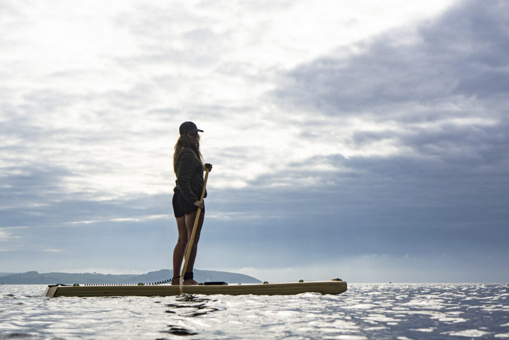 otter surfboards girl paddleboarding water sky