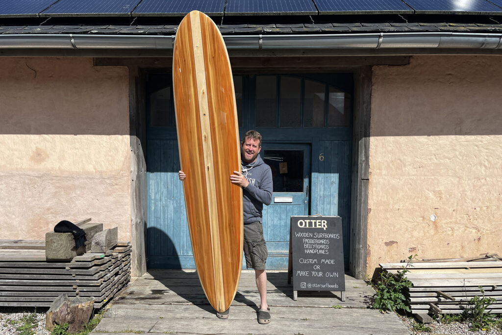 otter wooden surfboards workshop blue doors