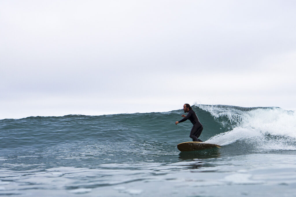 otter wooden surfboards bottom turn surfer wave sustainable