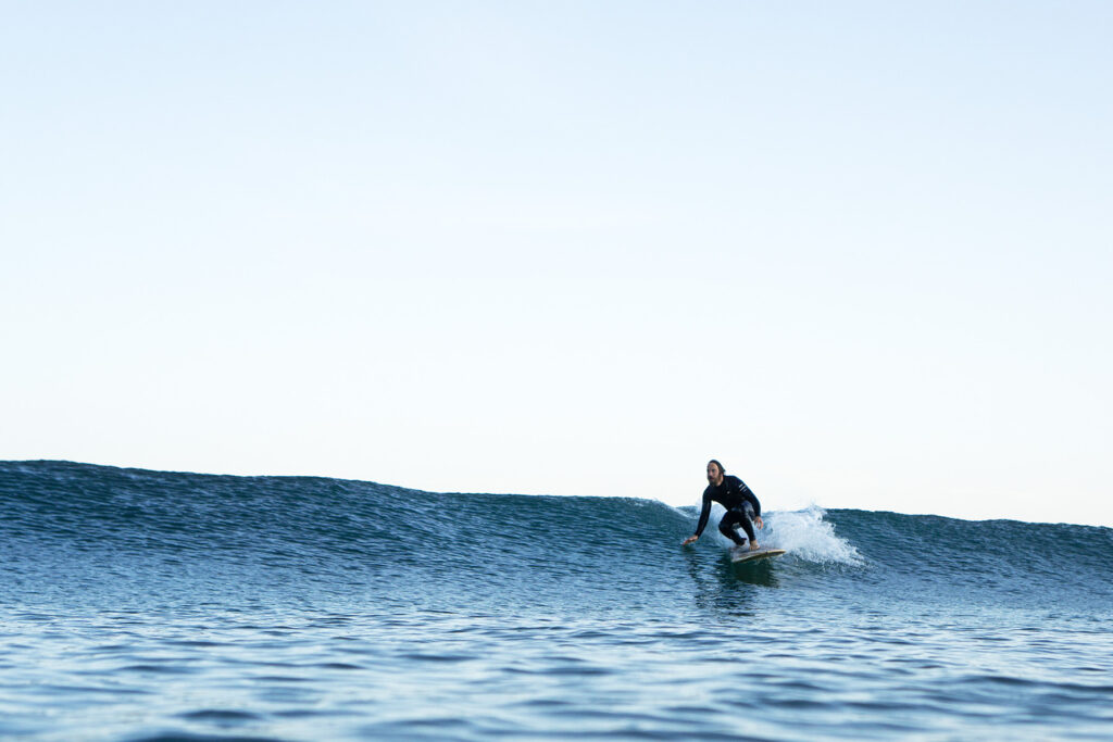 otter wooden surfboard surfer glassy wave surfing