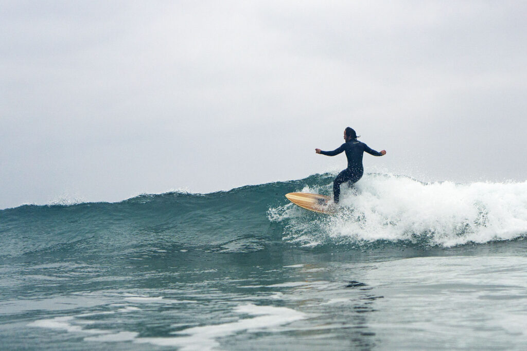 otter wooden surfboard surfer wave sustainable
