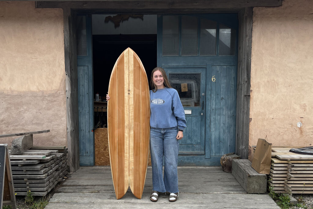 otter wooden surfboard workshop blue doors