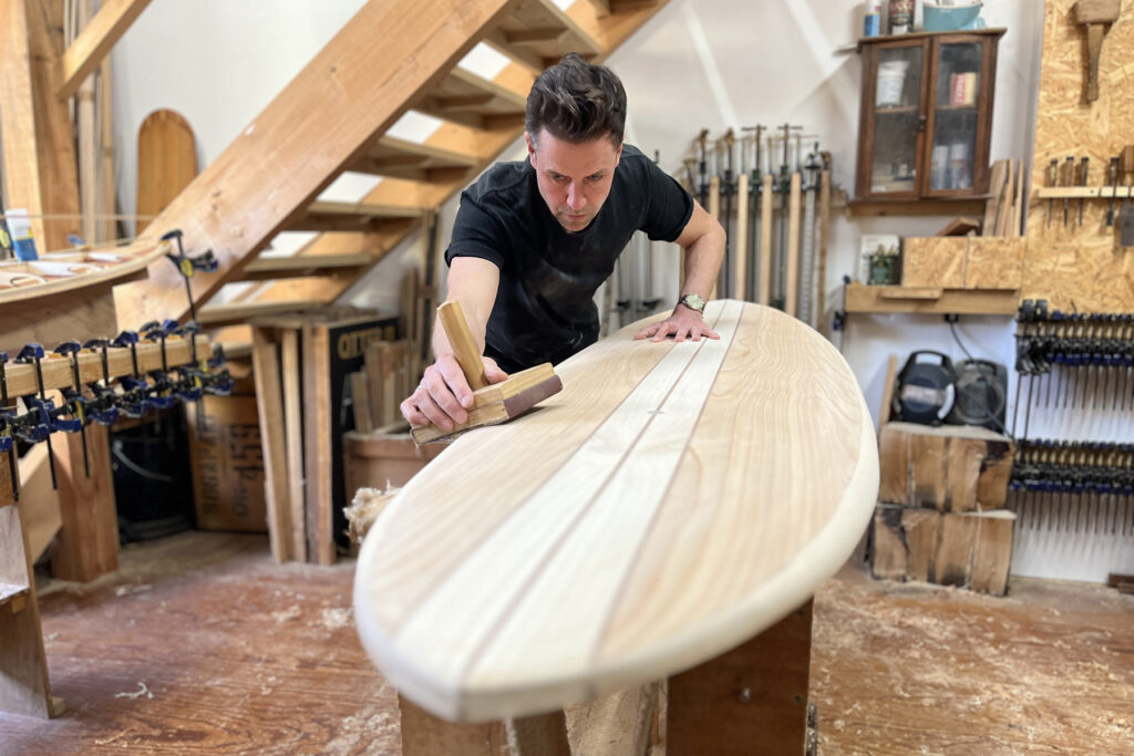 Gavin Otter Wooden Surfboard Coaster sanding the rails