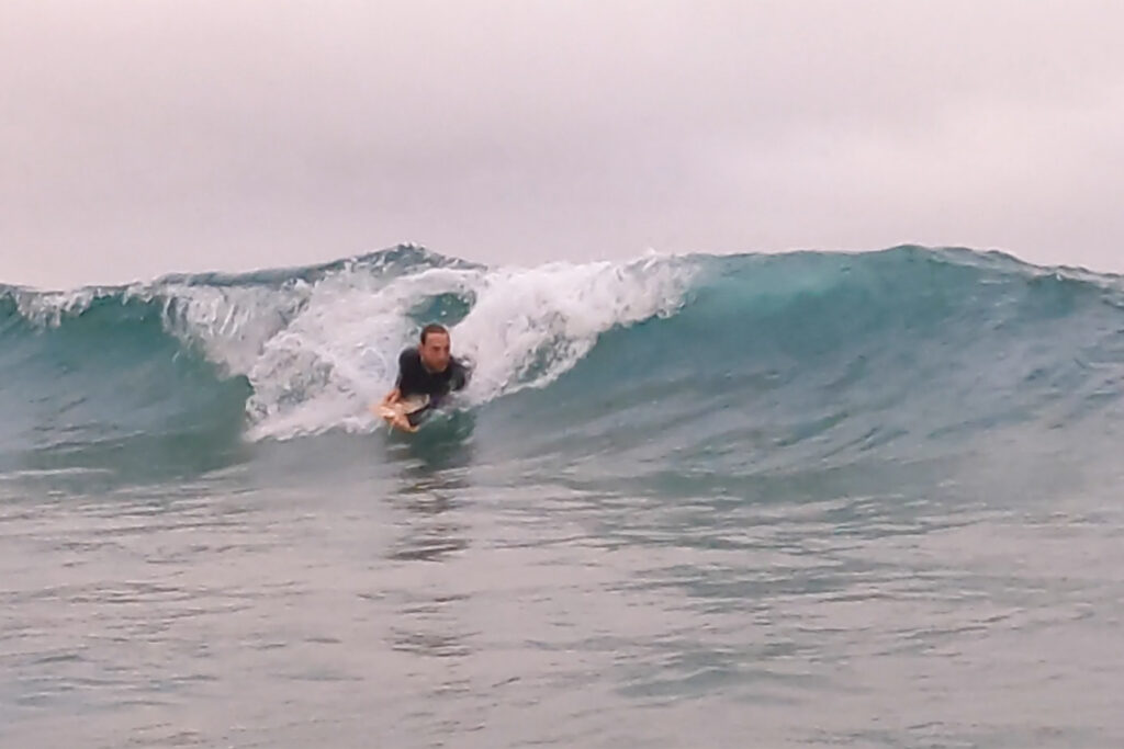 otter surfboards bellyboarding wave smile