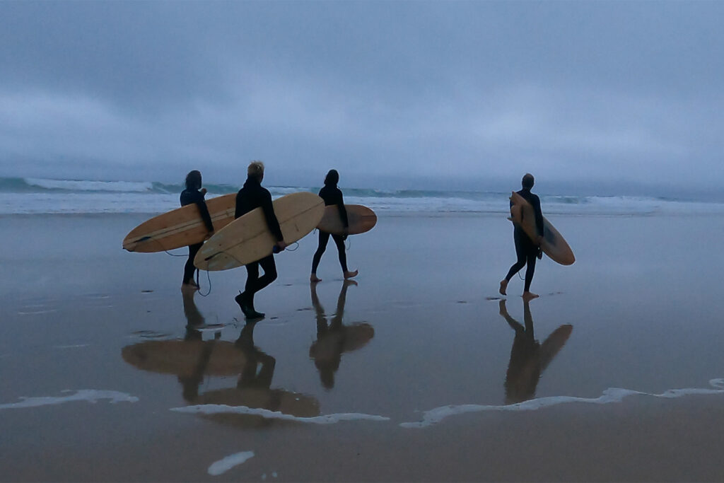 otter wooden surfboards group surfers beach