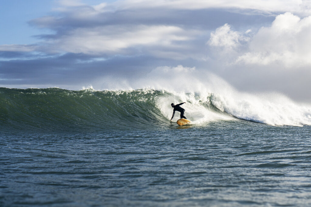 otter surfboards sustainable wooden surfboard surfer wave