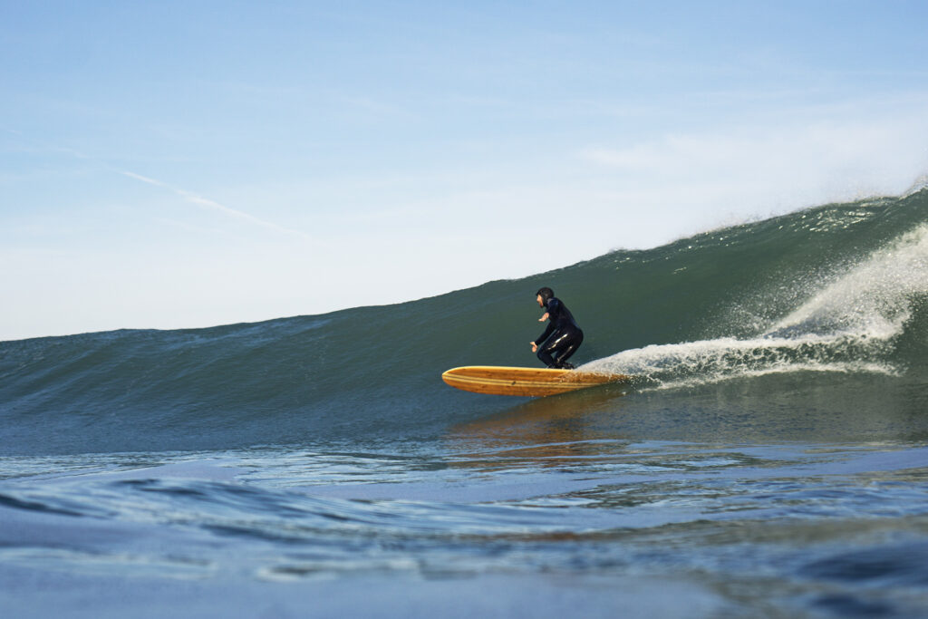 otter sustainable wooden surfboard surfer wave longboard
