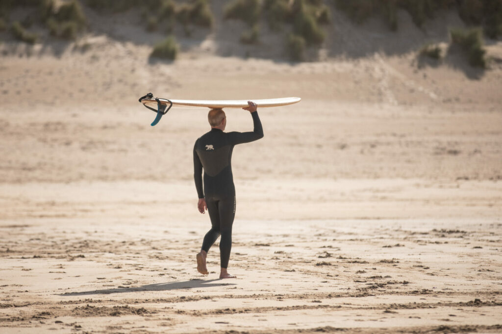 otter sustainable wooden surfboard surfer