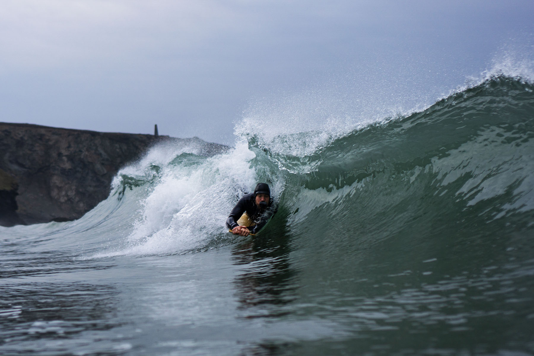 James Otter of Otter Surfboards slides into a barrel on his bellyboard