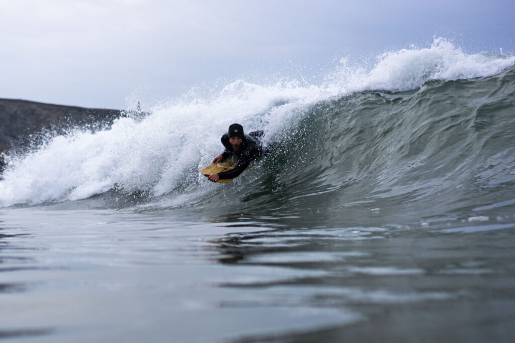 James Otter of Otter Surfboards slides into a barrel on his bellyboard
