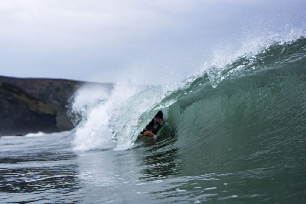 James Otter of Otter Surfboards slides into a barrel on his bellyboard