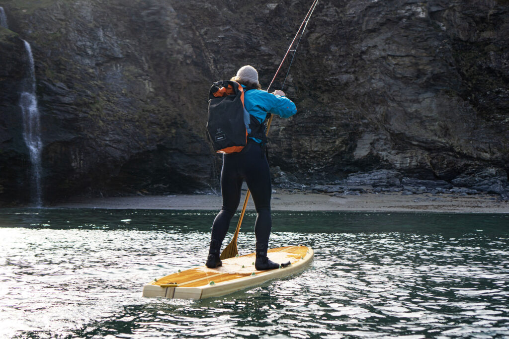 James Otter paddles one of his sustainable, wooden paddleboards.